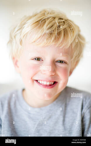 a-young-blonde-haired-boy-smiling-at-camera-KE4T6M