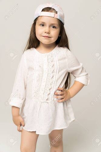 Cute Girl 5-6 Year Old Posing In Studio. Stock Photo, Picture And Royalty  Free Image. Image 127500669.