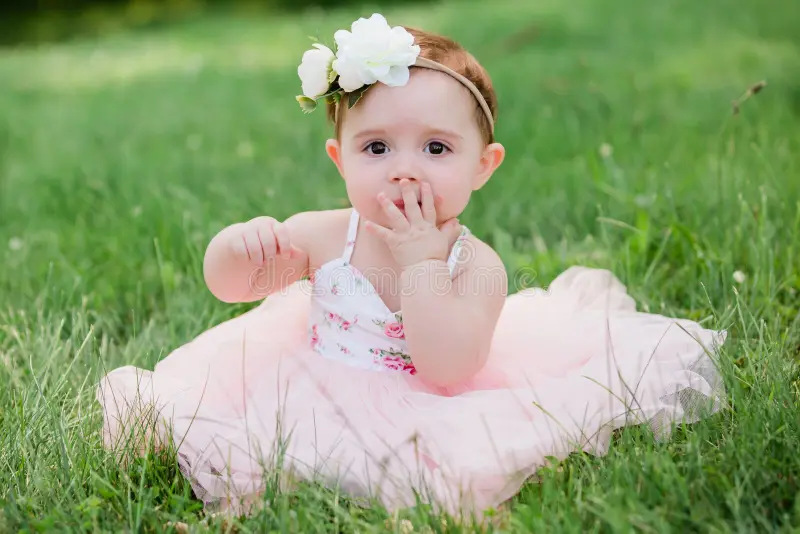 cute-one-year-old-caucasian-girl-outside-grass-wearing-pink-summer-dress-floral-headband-one-year-caucasian-old-girl-123250676