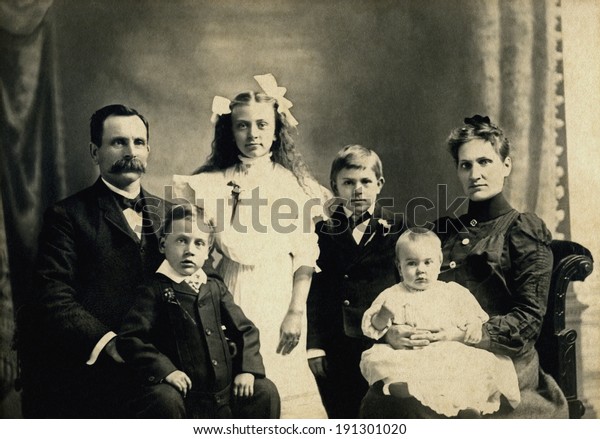 USA - MINNESOTA - CIRCA 1890 A vintage photo of a Victorian family. The parents are sitting with four children. The father has a mustache. This photo is from the Victorian era. CIRCA 1890